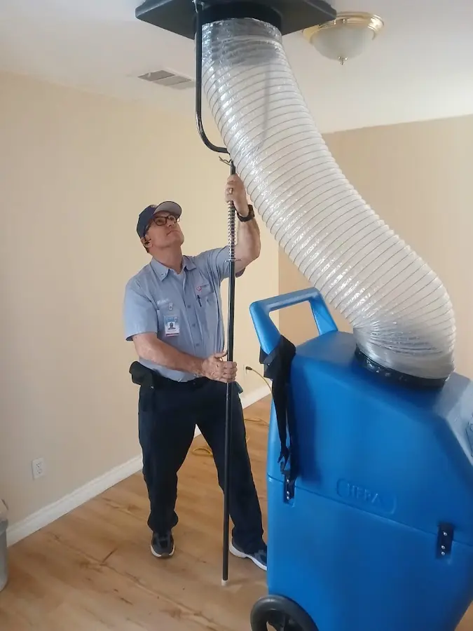 Furnace Tune-Up technician using HEPA equipment in Oakleaf Plantation